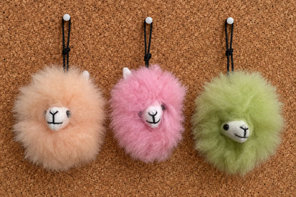 Plush fur pompom featuring a handcrafted faces in three colors