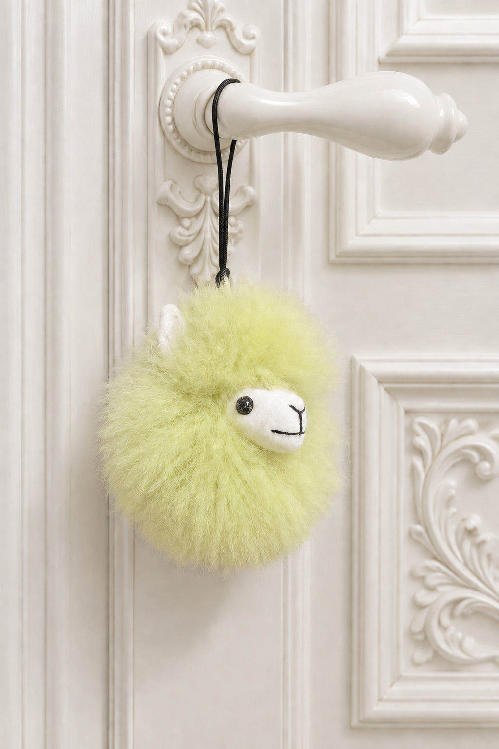 Plush fur pompom featuring a handcrafted face