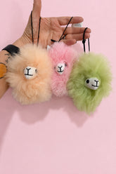 colorful, fun little alpaca face pompoms ready to hang