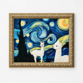 A framed wall art piece featuring two white alpacas set against a swirling blue and yellow night-sky style background, enclosed in an ornate gold frame and shown against a plain white wall.