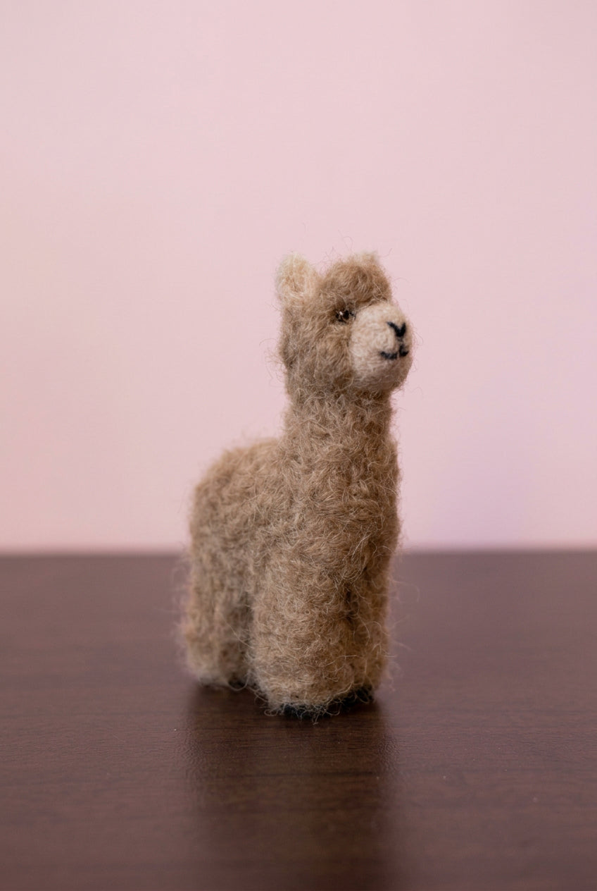 Needle felted tiny alpaca topper of a white jewelry box side view