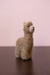 Needle felted tiny alpaca topper of a white jewelry box side view