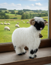 Handmade needle-felted alpaca Valais Blacknose sheep sculpture with a small rustic bell by Lanart.